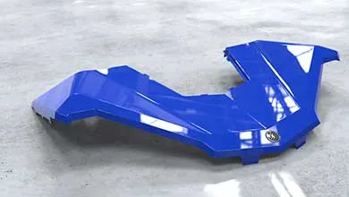 A glossy, angular royal blue Yamaha vehicle body panel rests on light gray concrete.