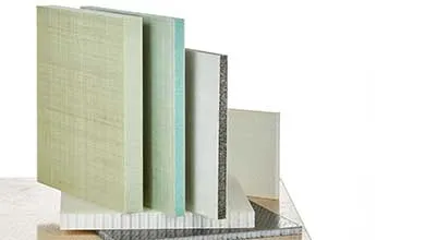 Several composite material samples stand upright, displaying different colors, textures, and core patterns on a white background.