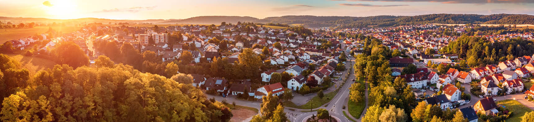 Aerial panorama of a European town at sunrise, with magnificent colorful sky and warm light